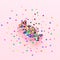 Decorative candy. Festive creative composition made of cookie form and colorful confetti at pastel pink background. Minimal