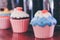 Decorative ceramic cupcakes on shelf in cafe