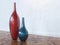 Decorative Ceramic Red And Blue Vases On Wooden Floor