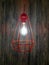 Decorative chandelier with light bulb. Decorative chandelier on wood background