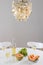 Decorative chandelier and table setting with wine