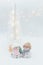 Decorative Christmas-themed figurines. Two statuette of a snowmen in a knitted hat on the white background.