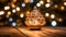 A decorative christmas tree on top of a wooden table lit up in bokeh