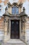 Decorative classicistic house gate on old decaying historical town house in Esztergom, Hungary.