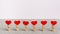 Decorative clothespins with red hearts for Valentine`s Day on a gray glittering background
