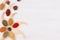 Decorative colorful border of multicolored asian spices and anise star, clove on white wooden background, copy space.
