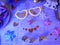 Decorative composition from Christmas decor on a wooden table, top view. Glowing carnival glasses, Christmas tree decorations