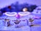 Decorative composition from Christmas decor on a wooden table, top view. Glowing carnival glasses, Christmas tree decorations