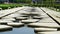 Decorative Concrete blocks over a man made lake. Decorative irregular concrete blocks arranged over a water body at a park