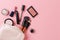Decorative cosmetic powder, concealer, eye shadow brush, blush, foundation on pink background