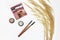 Decorative cosmetics, eye shadow, makeup brushes and a bouquet of dry grass