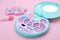 Decorative cosmetics for kids. Eye shadow palettes on pink background, closeup