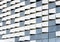 Decorative curved and perforated metal elements of the exterior wall of modern building