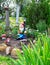 Decorative decoration of the garden. A ceramic figurine of a garden gnome in the backyard.