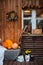 Decorative design window on the terrace. autumn wreath and pumpkins vintage old chest of drawers on wooden rustic