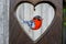 Decorative dream-catcher Bullfinch bird hanging in heart