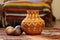 decorative earthenware pot on an african handwoven mat with kinara