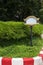 Decorative empty sign on a green lawn in a driveway, place for text