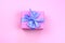 Decorative festive gift box with pink color on pink background.