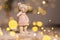 Decorative figurines of a Christmas theme. Figurine of a cute teddy bear girl in a sweater with deers. Festive decor, warm bokeh