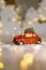 Decorative figurines of a Christmas theme. A statuette of a red car on which a teddy bear sits. Christmas tree decoration. Festive