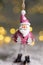 Decorative figurines of a Christmas theme. Statuette of Santa. Christmas tree decoration. Festive decor, warm bokeh lights