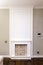 Decorative fireplace on the wall - modern interior. White frame and red brick