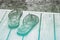 Decorative floral slip slops on a pool deck