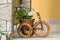 Decorative flowerpot in the garden in wicker bicycle. Heviz, Hungary