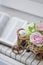 Decorative flowers roses in a wicker bicycle on the piano and the Bible. Topiary. Wedding decor, decoration.