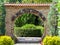 Decorative gate in the garden park. Brick wall with a circular passage