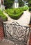 Decorative Gate Leads To White Gravel and Detailed Landscaping at Residence`