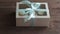 Decorative gift box tied with cupcakes a turquoise ribbon in female hands