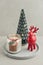 Decorative glass fir tree with red  ceramic deer and candle in jar