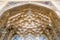 Decorative golden muqarnas vaulting with mirror work at the entrance of the Chehel Sotoun Palace.