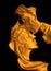 Decorative golden sculpture of kissing couple on black backdrop