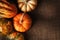 Decorative gourds and pumpkins on a burlap surface with copy space and warm side light