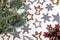 Decorative green frosty pine branch with cones, red snowflake with red berries, silver and gold stars, snowflakes, angels