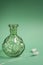Decorative green glass vase with white plumes