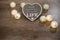 Decorative handmade heart with text and lights on the wooden table