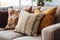 decorative handmade pillows on a neutral-toned couch
