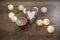 Decorative heart, lights and cup of coffee on the wooden table