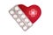 Decorative heart and pills with the icon of the glowing medical red cross. Concept of healthy heart Top view Flat lay. Heart And