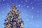 Decorative illuminated Christmas tree, bokeh lights, holiday background