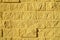 Decorative imitation of brickwork light yellow color - the wall of the house. Background