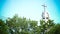 Decorative iron christian cross atop church steeple on brick tower