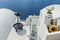 Decorative items adorn the roofs of traditional Greek houses and romantic staircase, leading to the Mediterranean sea. Santorini