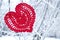 Decorative knitting heart on fir-tree branch. Winter holidays concept. Love concept background. February 14. Textile red heart on