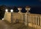 Decorative lanterns and flowerpots with geraniums stand on the railing of the stairs leading from Bahai Garden upper entrance, at