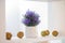 Decorative lavender in a white flowerpot on the shelf